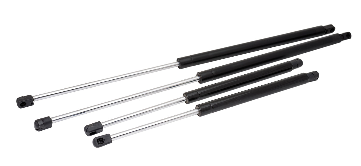 Set of four black metal gas struts on a white background