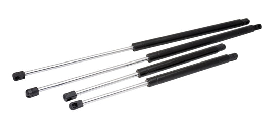 Set of four black metal gas struts on a white background